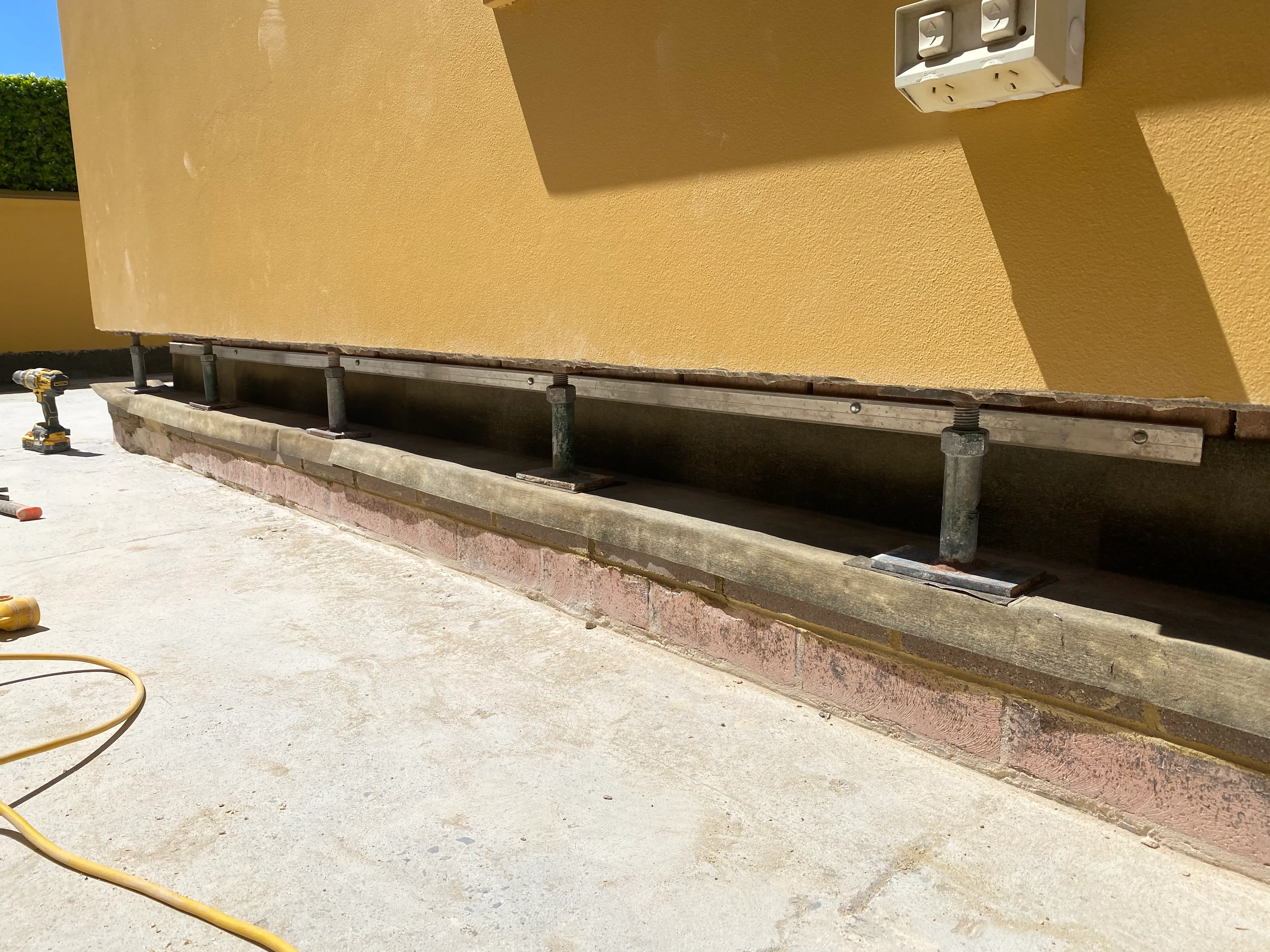 Cavity flashing remediation work on a Sydney brick wall