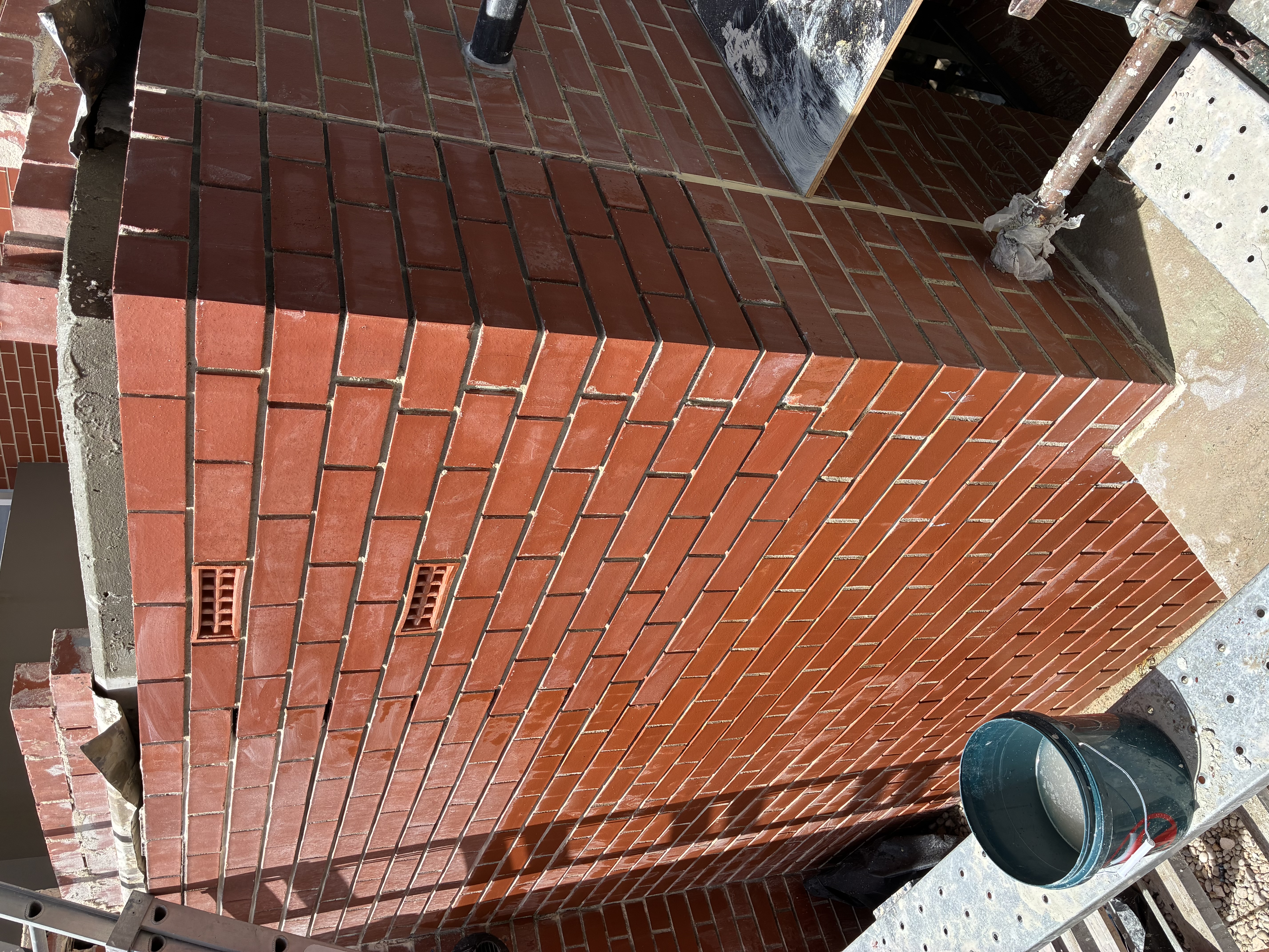Finished brick pier corner rebuilt in matched red brick after fretting brick replacement
